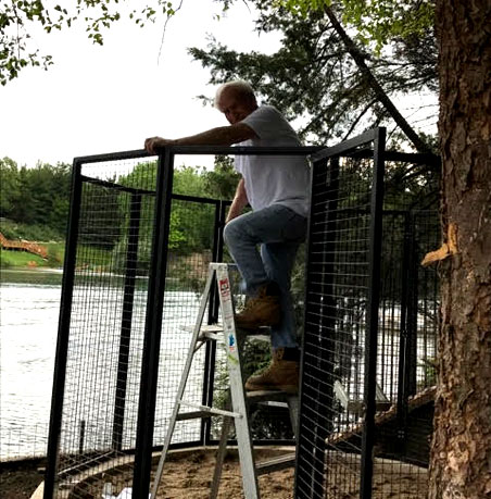 man installing chicken enclosure